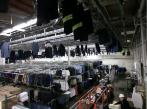 Garments handing from rails to be sorted