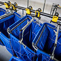 Bins on a laundry rail system