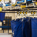 Bins on a laundry rail system