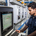 Man at laundry rail system computer